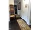 Hallway with decorative rugs and wall art, leading to other rooms in the house at 3607 Buffaloe Rd, Raleigh, NC 27604
