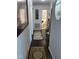 Hallway with decorative rugs and wall art, leading to other rooms in the house at 3607 Buffaloe Rd, Raleigh, NC 27604