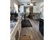 Open concept kitchen with modern appliances and a view into the living room area at 3607 Buffaloe Rd, Raleigh, NC 27604