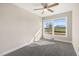 Bright bedroom featuring a ceiling fan, neutral paint, new carpet and a large window at 3639 Nc Highway 39, Selma, NC 27576