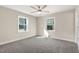 Bedroom featuring neutral paint, new carpet, ceiling fan and two large windows at 3639 Nc Highway 39, Selma, NC 27576