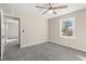 Bedroom with fresh paint, new carpet, a ceiling fan, and large window at 3639 Nc Highway 39, Selma, NC 27576