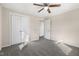 Bedroom featuring wood-look paneling, carpet, and doorways to the hall and closet at 3639 Nc Highway 39, Selma, NC 27576