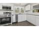 Modern kitchen featuring stainless steel appliances, granite countertops, and white cabinets at 3639 Nc Highway 39, Selma, NC 27576