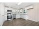 Modern kitchen featuring stainless steel appliances, granite countertops, and white cabinets at 3639 Nc Highway 39, Selma, NC 27576