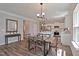 Open-concept dining area with a modern table, leading to a bright kitchen with stainless steel appliances at 37 E American Marigold Dr # 35, Benson, NC 27504