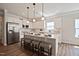 Bright, open kitchen featuring white cabinets, stainless steel appliances, a large center island and breakfast bar seating at 37 E American Marigold Dr # 35, Benson, NC 27504