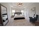 Serene main bedroom with tray ceilings, a king bed, neutral tones, and natural light from two windows at 37 E American Marigold Dr # 35, Benson, NC 27504