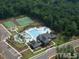 Aerial view of community amenities including a clubhouse, pool, basketball court, and tennis courts at 401 River Falls Dr, Apex, NC 27539