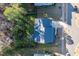 An aerial view of the house shows the roof, driveway, and the surrounding wooded area at 401 River Falls Dr, Apex, NC 27539