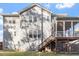 Rear view of the home showing a screened porch and a backyard with green grass at 401 River Falls Dr, Apex, NC 27539