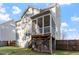 Picture of back of house with a screened porch, stairs leading to fenced backyard at 401 River Falls Dr, Apex, NC 27539