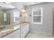 Spacious bathroom with double vanity, granite counters, large mirror, and walk-in shower at 401 River Falls Dr, Apex, NC 27539