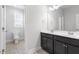 Bathroom with gray cabinets, white countertops, toilet, and gray tiled floors at 401 River Falls Dr, Apex, NC 27539