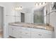 Spacious bathroom featuring double sinks with granite counters and a large mirror at 401 River Falls Dr, Apex, NC 27539