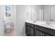 Bathroom with double sink, white countertop, and dark cabinets at 401 River Falls Dr, Apex, NC 27539