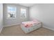 Cozy bedroom featuring carpet, two windows, and a daybed with drawer storage at 401 River Falls Dr, Apex, NC 27539