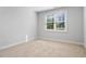 This bedroom has neutral colored walls, one window, and neutral carpet at 401 River Falls Dr, Apex, NC 27539