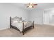 Spacious bedroom with carpet, ceiling fan, window, and wrought iron bed frame at 401 River Falls Dr, Apex, NC 27539