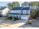Charming two-story home with a manicured lawn, inviting porch, and attached two car garage at 401 River Falls Dr, Apex, NC 27539