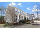 Inviting exterior featuring a covered porch with stone accents and lush landscaping at 401 River Falls Dr, Apex, NC 27539