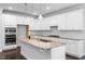 Bright kitchen features granite countertops, stainless steel appliances, and modern lighting fixtures at 401 River Falls Dr, Apex, NC 27539