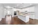 Spacious kitchen with white cabinetry, granite countertops, stainless appliances, and hardwood floors at 401 River Falls Dr, Apex, NC 27539