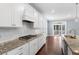 Bright kitchen featuring granite counters, stainless steel appliances and gas range cooktop at 401 River Falls Dr, Apex, NC 27539