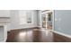 Bright living space featuring hardwood floors, with a large window, and a sliding glass door at 401 River Falls Dr, Apex, NC 27539