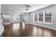 Open-concept living area features beautiful floors, bright windows, and a neutral color palette at 401 River Falls Dr, Apex, NC 27539