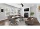 Bright living room features a modern fireplace, large windows, and comfortable seating area at 401 River Falls Dr, Apex, NC 27539