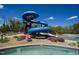 Community pool slide with lush landscaping surrounding the water feature at 401 River Falls Dr, Apex, NC 27539