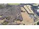 Aerial view of tree-surrounded home, pond and field at 4639 Reid Rd, Elon, NC 27244