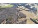 Aerial view of tree-surrounded home, pond and field, taken in winter at 4639 Reid Rd, Elon, NC 27244