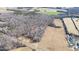 Aerial view of tree-surrounded home, pond and field at 4639 Reid Rd, Elon, NC 27244