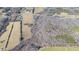 Expansive aerial view of a property with a home surrounded by fields and woods on a sunny day at 4639 Reid Rd, Elon, NC 27244