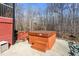 Backyard patio featuring a hot tub and wooded landscape views at 4639 Reid Rd, Elon, NC 27244