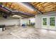 Spacious unfinished basement featuring exposed ceiling and access to the backyard through double doors at 4639 Reid Rd, Elon, NC 27244