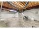 Unfinished basement with concrete floor, exposed ceiling, and a generator at 4639 Reid Rd, Elon, NC 27244