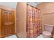 A bathroom with a colorful shower curtain at 4639 Reid Rd, Elon, NC 27244