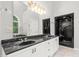 Bathroom featuring dual sinks, marble countertops, framed mirrors, and a walk-in shower at 4639 Reid Rd, Elon, NC 27244