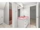 Unique bathroom features a retro pink vanity, neutral walls, and a bathtub in the adjoining space at 4639 Reid Rd, Elon, NC 27244