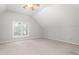 A bright bedroom features neutral walls and carpet, a ceiling fan, and a window with natural light at 4639 Reid Rd, Elon, NC 27244