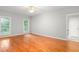 Spacious bedroom features beautiful hardwood floors and large windows with views of lush greenery at 4639 Reid Rd, Elon, NC 27244