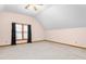 Bright bedroom with vaulted ceilings, large window, neutral carpet, and fan with lighting at 4639 Reid Rd, Elon, NC 27244