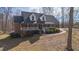 Traditional brick home features a welcoming front porch, dormer windows, and mature landscaping at 4639 Reid Rd, Elon, NC 27244
