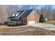 Charming two-story brick home features an attached garage and well-manicured front yard at 4639 Reid Rd, Elon, NC 27244