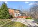 Exterior elevation of red brick house, including covered patio and walkway at 4639 Reid Rd, Elon, NC 27244