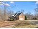 Stately brick home with an expansive front porch and ample parking on the driveway at 4639 Reid Rd, Elon, NC 27244