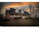 Charming brick home boasts a welcoming front porch, perfect for relaxing evenings at 4639 Reid Rd, Elon, NC 27244